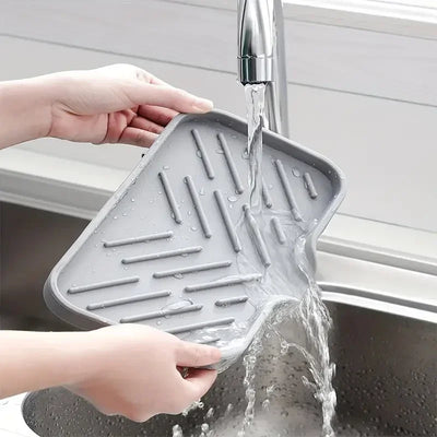 Silicone Sink Tray – Soap & Sponge Holder with Drain being rinsed under kitchen faucet