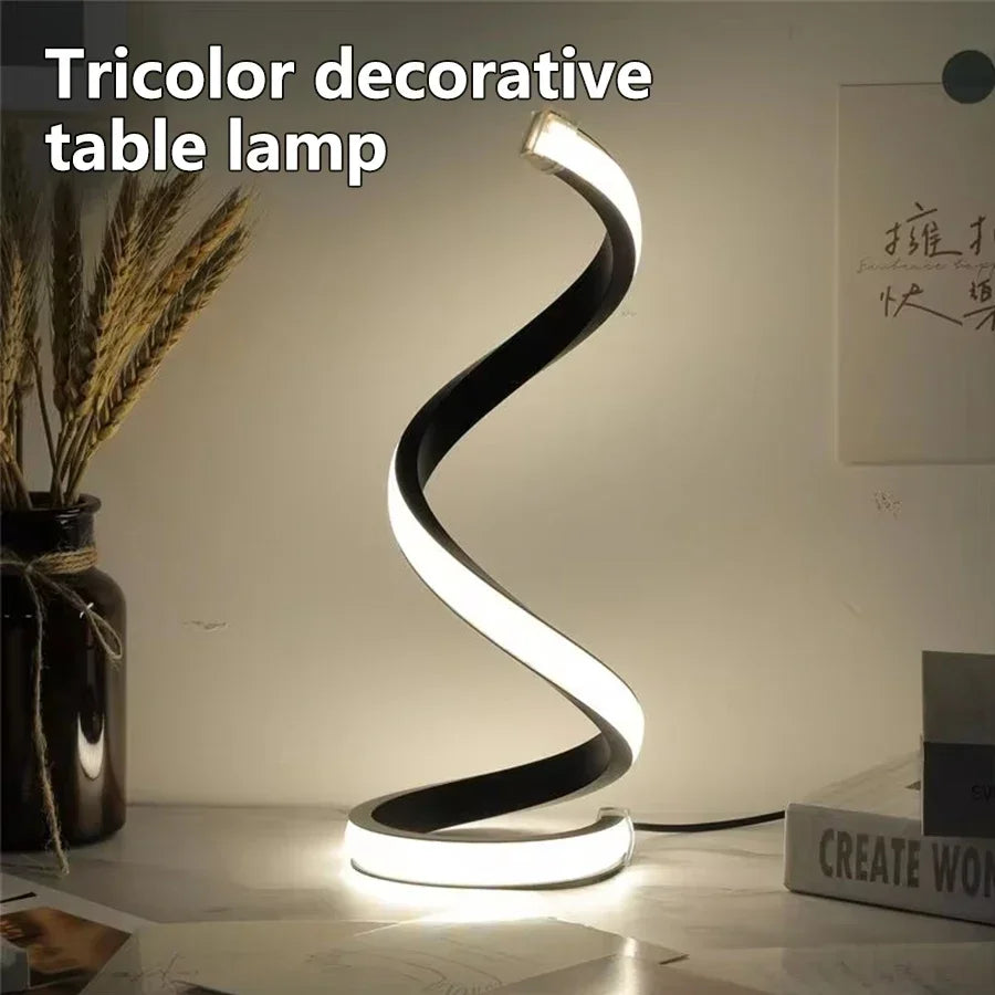 Modern Spiral LED Color Lighting Modes desk lamp glowing on a desk with warm light.