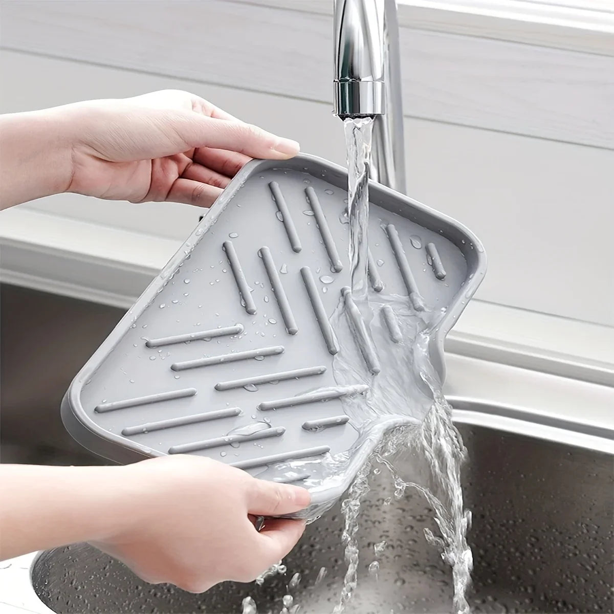 Silicone Sink Tray – Soap & Sponge Holder with Drain being rinsed under a kitchen faucet.