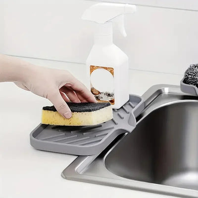 Silicone Sink Tray – Soap & Sponge Holder with Drain holding a sponge near a sink.